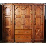 A Victorian ecclesiastical pitch pine hall robe, the central pair of doors mounted on brass Gothic