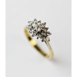 A diamond set cluster ring, the fifteen brilliant cut diamonds, all within white metal claw setting,