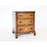 An 18th century style burr walnut chest of drawers, the quarter veneered and cross banded top