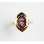 An amethyst set ring in 9ct yellow gold, the central oval amethyst, collet set in a 9ct yellow