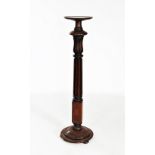 A 19th century mahogany torchere, with reeded acanthus leaf pedestal upon a circular plinth base