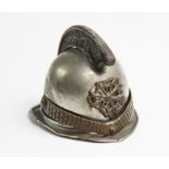 An early 20th century novelty French fireman's helmet match holder or vesta, applied with front