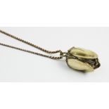 A silver gilt watch pendant on chain, designed as a hanging fruit with three hinged locket 'leaf'