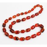 A 'Cracked' amber bead necklace, designed as a single strand of thirty seven beads, gross weight