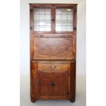 A 1930s oak and plywood 'Maidsaver' kitchen unit, with a pair of leaded glazed doors above a fall