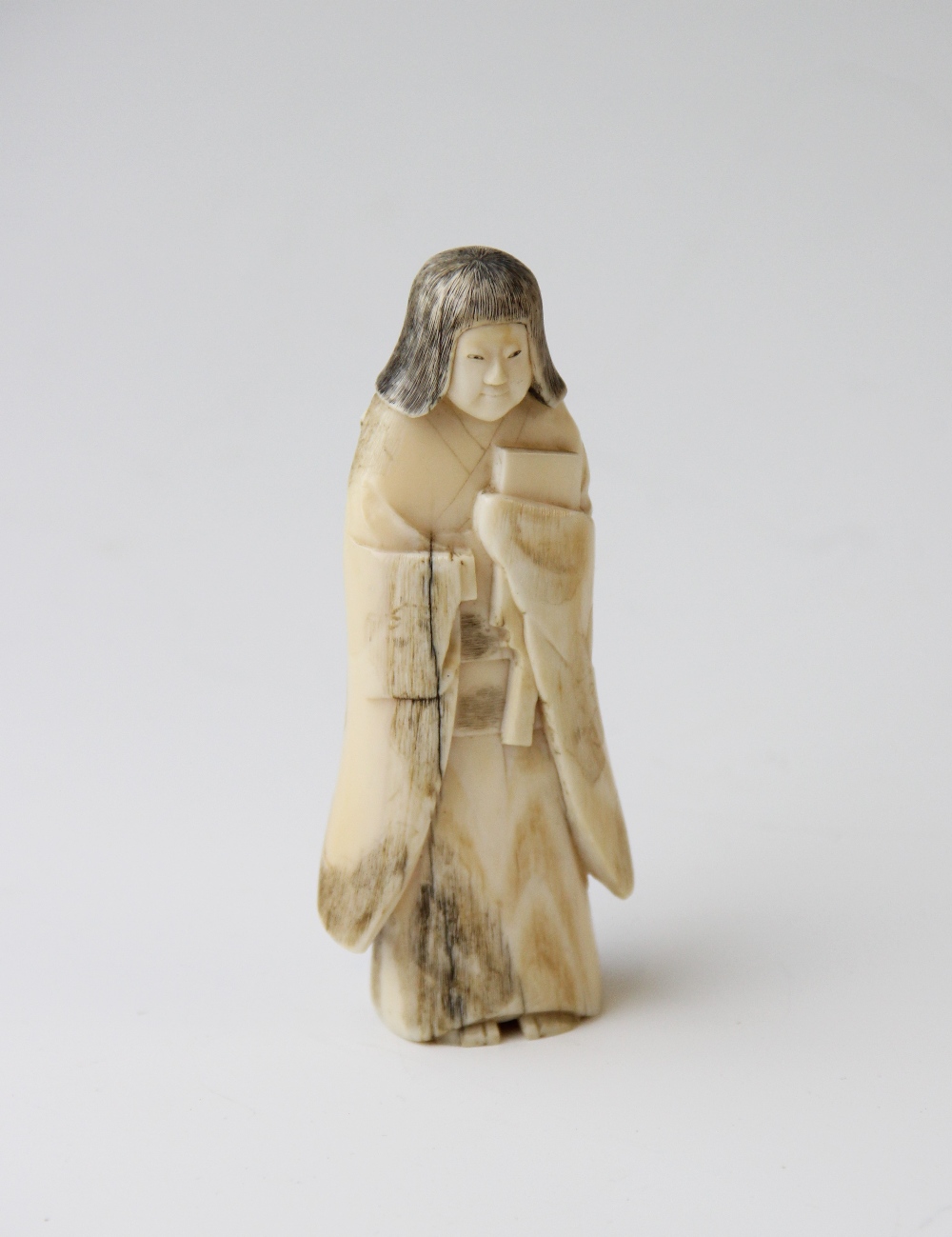 A Japanese carved figure, Meiji period (1868-1912), the female figure modelled standing with details