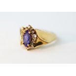An amethyst set dress ring, designed as a central marquise cut stone, within a further stone set