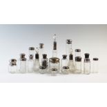 A large selection of silver mounted dressing table jars and bottles, 19th century and later, to