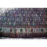 A large Caucasian pattern wool carpet, the central panel with repeating multi coloured guls on a