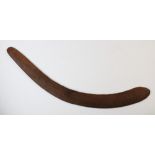 An Aboriginal boomerang, with fluted carving to the upper side, 61cm long