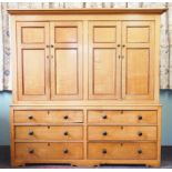 A mid 19th century honey oak housekeepers cupboard, with a cavetto cornice above two pairs of