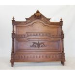 A French Louis XV style walnut bed, late 19th century, the arched headboard with a carved