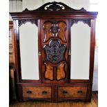 A late Victorian walnut and burr walnut double wardrobe, with a moulded stepped cornice above a