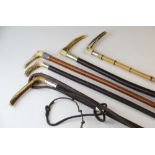 Five assorted riding crops, to include, a bamboo example with horn handle and silver mount, a