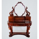 A Victorian mahogany duchess dressing table, the quatrefoil shaped mirror raised upon scrolling