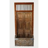 A Rajasthani rustic hardwood balcony door, with an iron bar grille above a pair of panelled doors,