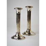A pair of silver candlesticks, Clark and Sewell Chester 1926, each of fluted column form and upon
