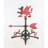 An early 20th century Welsh dragon wrought iron weather vane, the painted dragon above a revolving