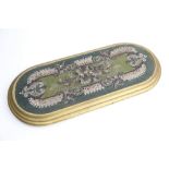 A Victorian oval bead work stand, the gilt wood frame enclosing the foliate bead work panel,
