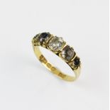 A Victorian 18ct gold stone set ring, comprising five graduated mine cut paste stones, claw set in