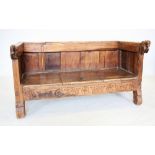 A Rajasthani carved hardwood bench, the substantial top rail extending to carved horse terminals,