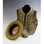A Turkish Ottoman Empire waistcoat, profusely embroidered in golden threads with turquoise and coral