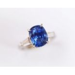 A sapphire and diamond ring, the central rectangular, cushion mixed cut sapphire within a four
