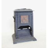An early 20th century Rippengilles iron conservatory stove, the pierced rectangular top with a