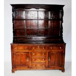 A mid 18th century North Walian oak dresser, the high back with a moulded cornice above a shaped