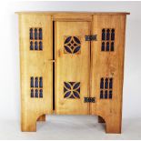 A modern light oak Gothic influence side cabinet, the central door mounted with iron butterfly