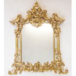 A French Rococo style giltwood wall mirror, 20th century, the scrolling foliate open work frame