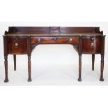 A George III Irish serpentine mahogany sideboard, the gallery central panel carved with a harebell