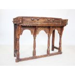 A Rajasthani rustic hardwood balcony console table, with a carved panel above a lower shelf,