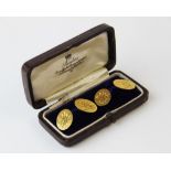 A pair of yellow metal cufflinks, stamped '18ct', each oval disc (monogrammed) joined by a bar link,