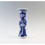 A Chinese blue and white prunus Gu vase, 19th century, of typical phoenix tail form, double