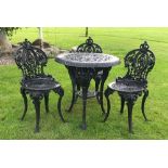 A cast iron assembled bistro set, comprising; a Britannia cast circular table (cast in three