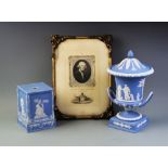 A Wedgwood blue jasperware urn and cover, the urn of typical form decorated with pastoral scenes,