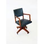 A mid 20th century revolving office desk chair, with padded back and sprung seat enclosed by stained