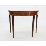 A 19th century mahogany demi-lune folding games table, the circular top above a plain frieze and