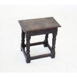 An 18th century style oak joint stool, early 20th century, with a nulled frieze upon turned legs and