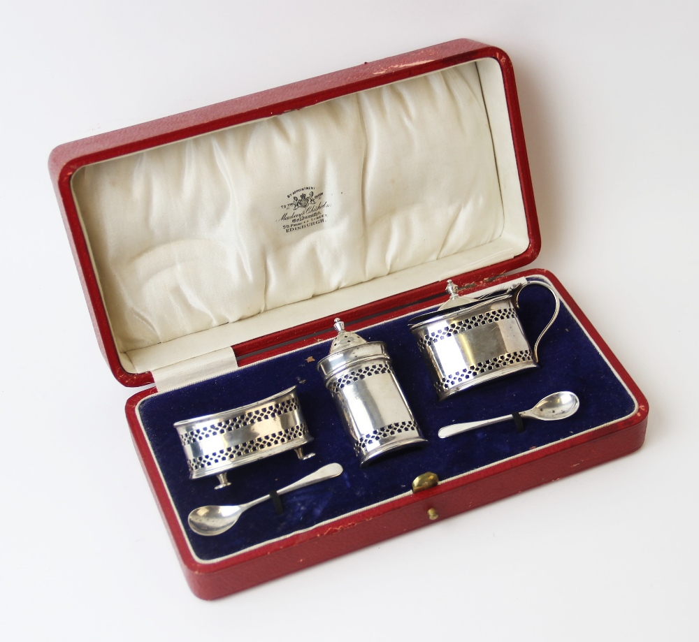 A George V three-piece silver condiment set, Adie Brothers, Birmingham 1928, comprising a wet