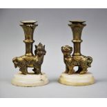 A pair of Chinese cast brass zoomorphic candlesticks, late 19th century, modelled in the archaic