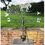 A painted steel weather vane with horse and plough detail and N, E, S and W denominations, with wall