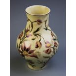 A squat baluster vase by Zsolnay Pecs, Hungary, applied with polychrome floral designs upon a