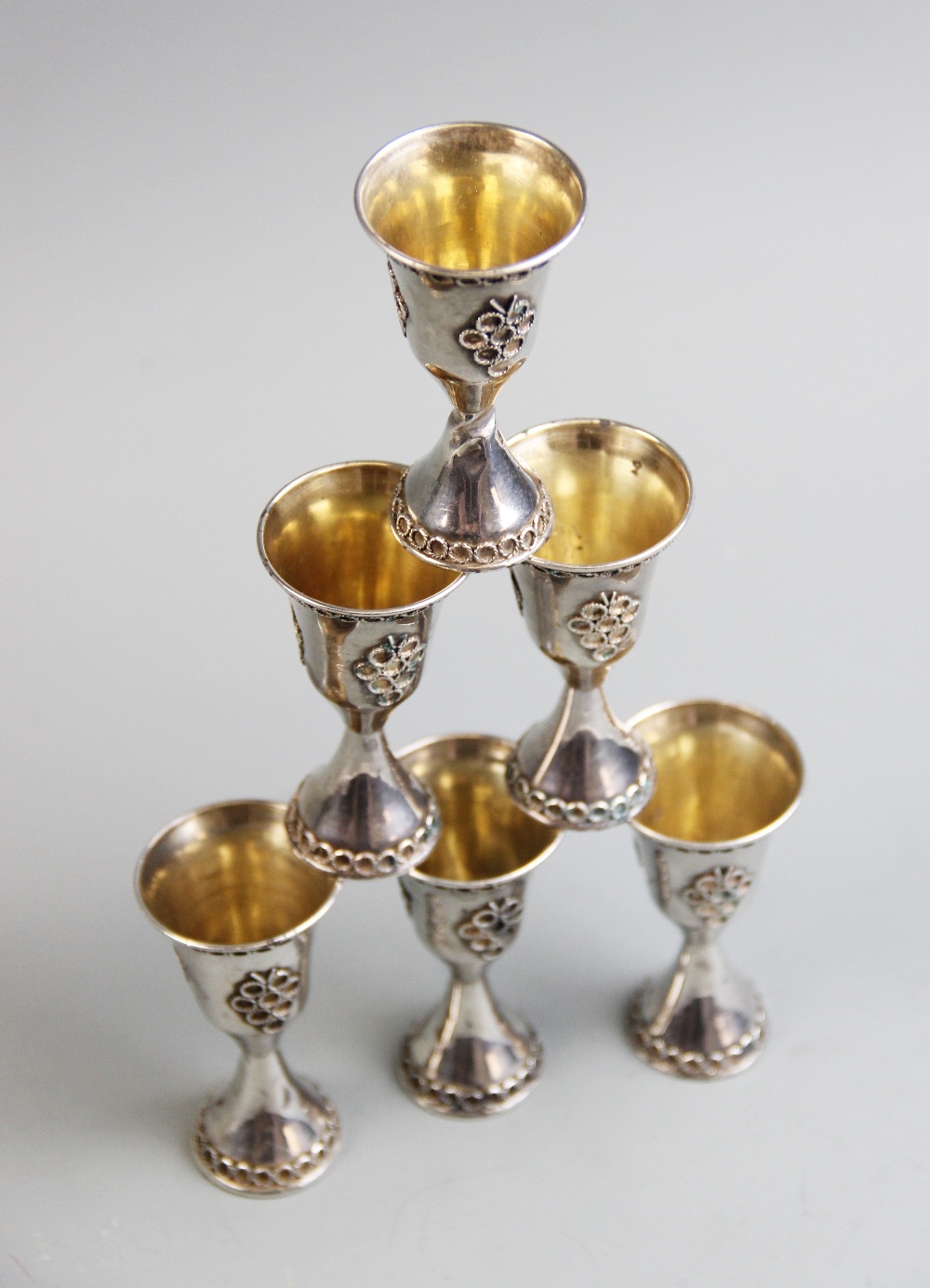 A set of six silver Middle Eastern liqueur cups, of tapering form, each decorated with stylized - Image 2 of 2