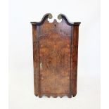 A Queen Anne style burr walnut hanging corner cupboard, 19th century, with a twin swan neck pediment