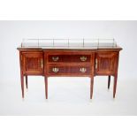 A George III style mahogany breakfront sideboard, late 20th century, with a brass rail above the