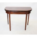 An early 19th century mahogany tea table, of 'D' form with a reeded edge, raised upon legs of