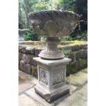 A pair of reconstituted stone garden urns, each of bowl form and cast with anthemion and acanthus