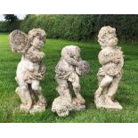 A set of three reconstituted stone allegorical figures, each modelled with a musical instrument,